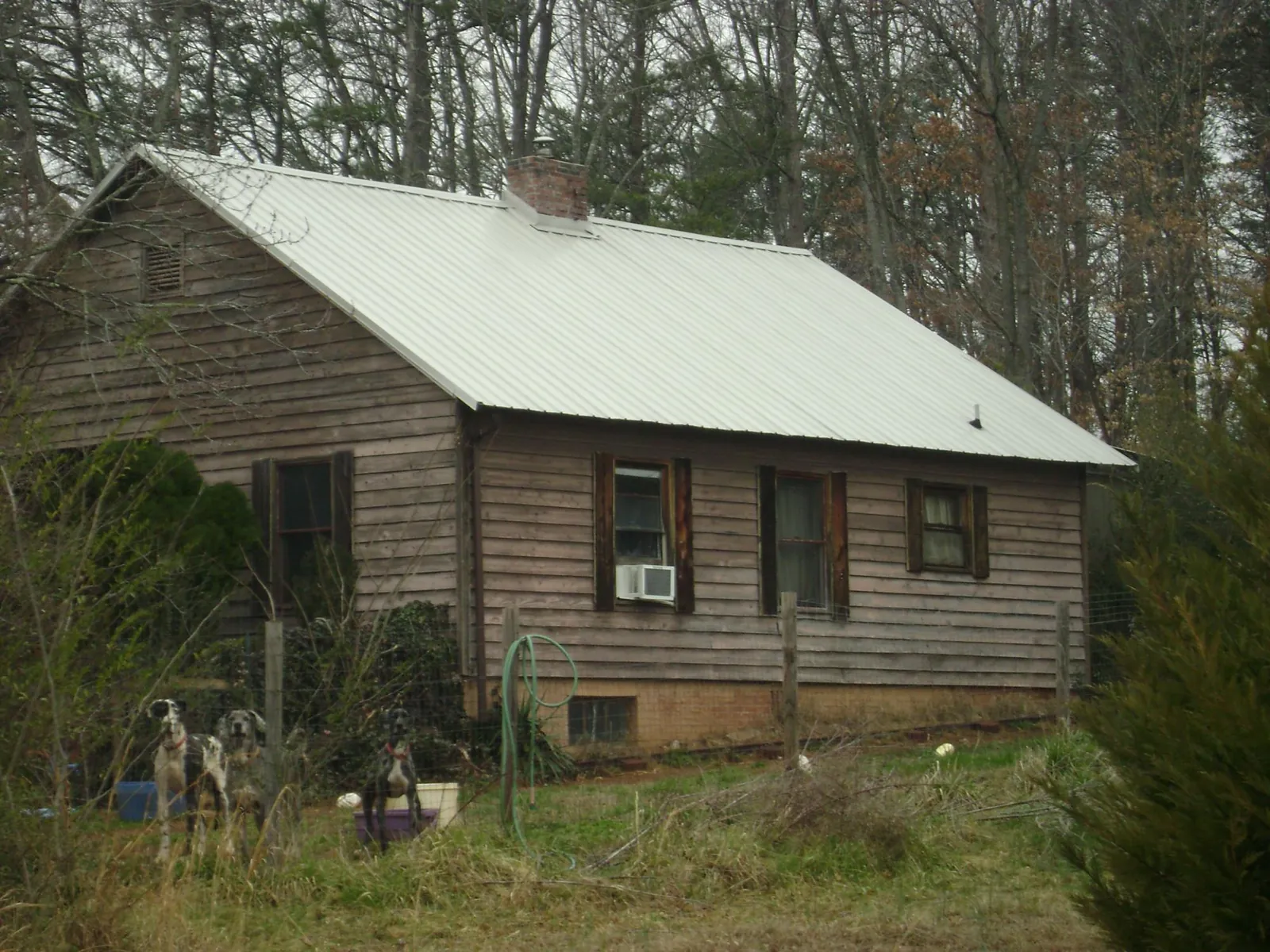 White metal roof on an old wood sided farmhouse, from a Metal Roof Installation job in Bethlehem